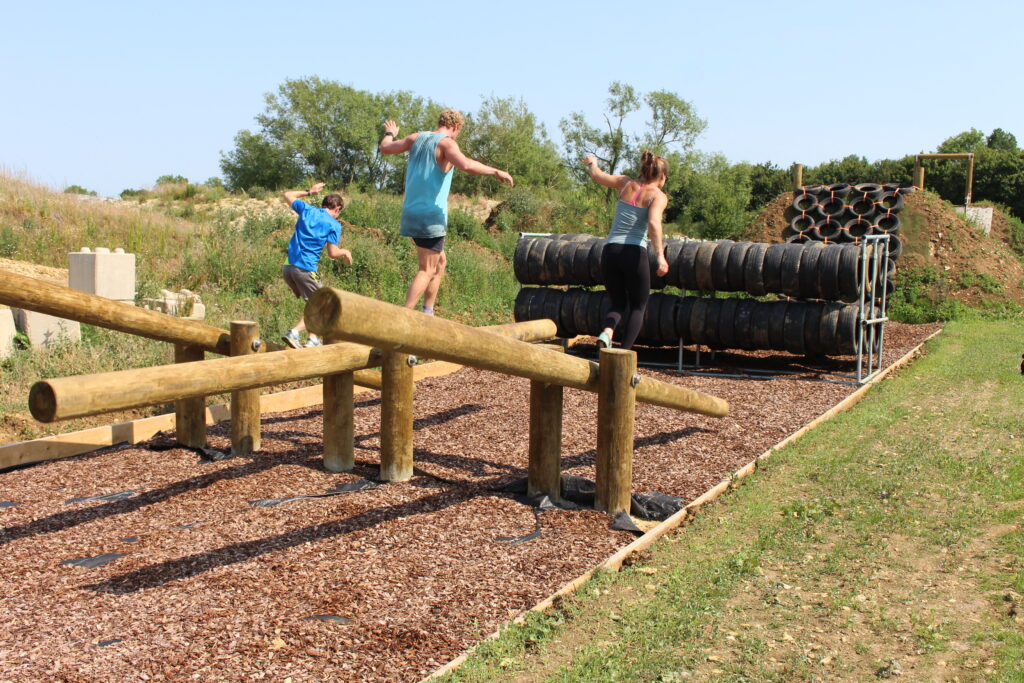 Gym members on balance beam