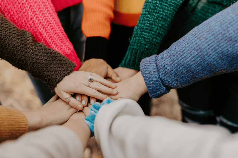 lots of hands all together in a circle